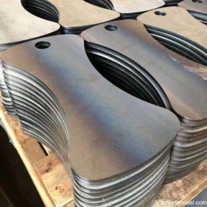 Nested steel parts on a cutting bed after laser processing